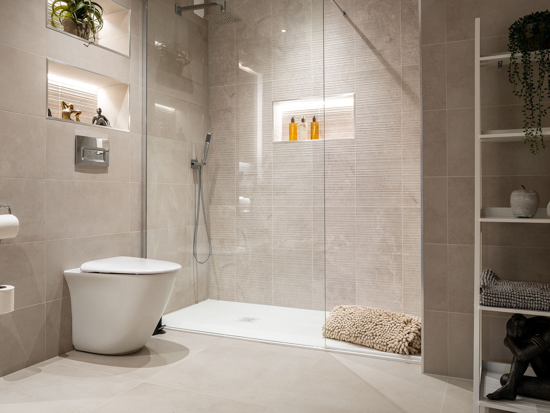 A bathroom with a toilet and a walk in shower.