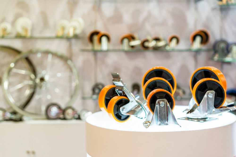 A Bunch of Orange Wheels Are Sitting on Top of a White Table — Coffs Harbour Bearing Centre in Coffs Harbour, NSW