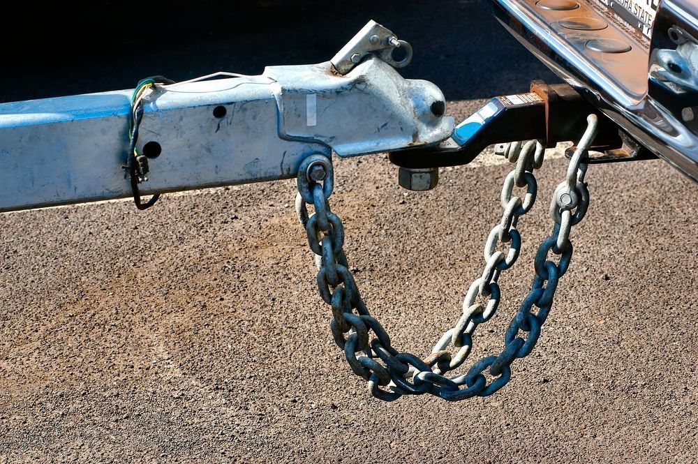 A Trailer is locked into the tow bar of a car — Coffs Harbour Bearing Centre in Coffs Harbour, NSW