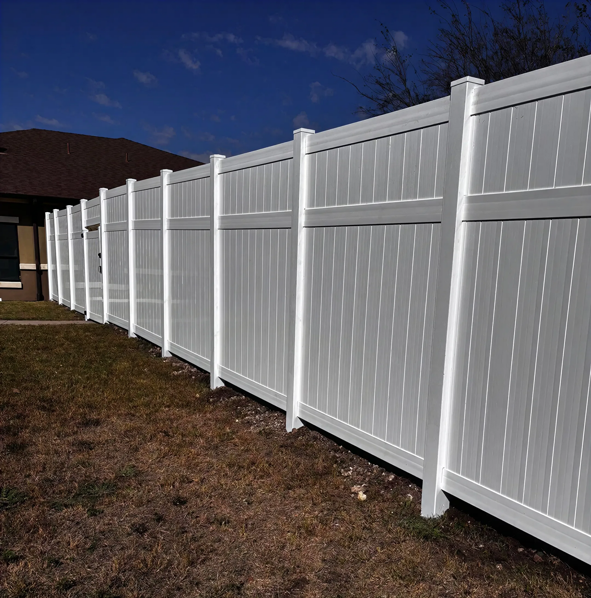 Commercial R-panel fence with trim installed by Rollins Fence Company in White Settlement, Texas