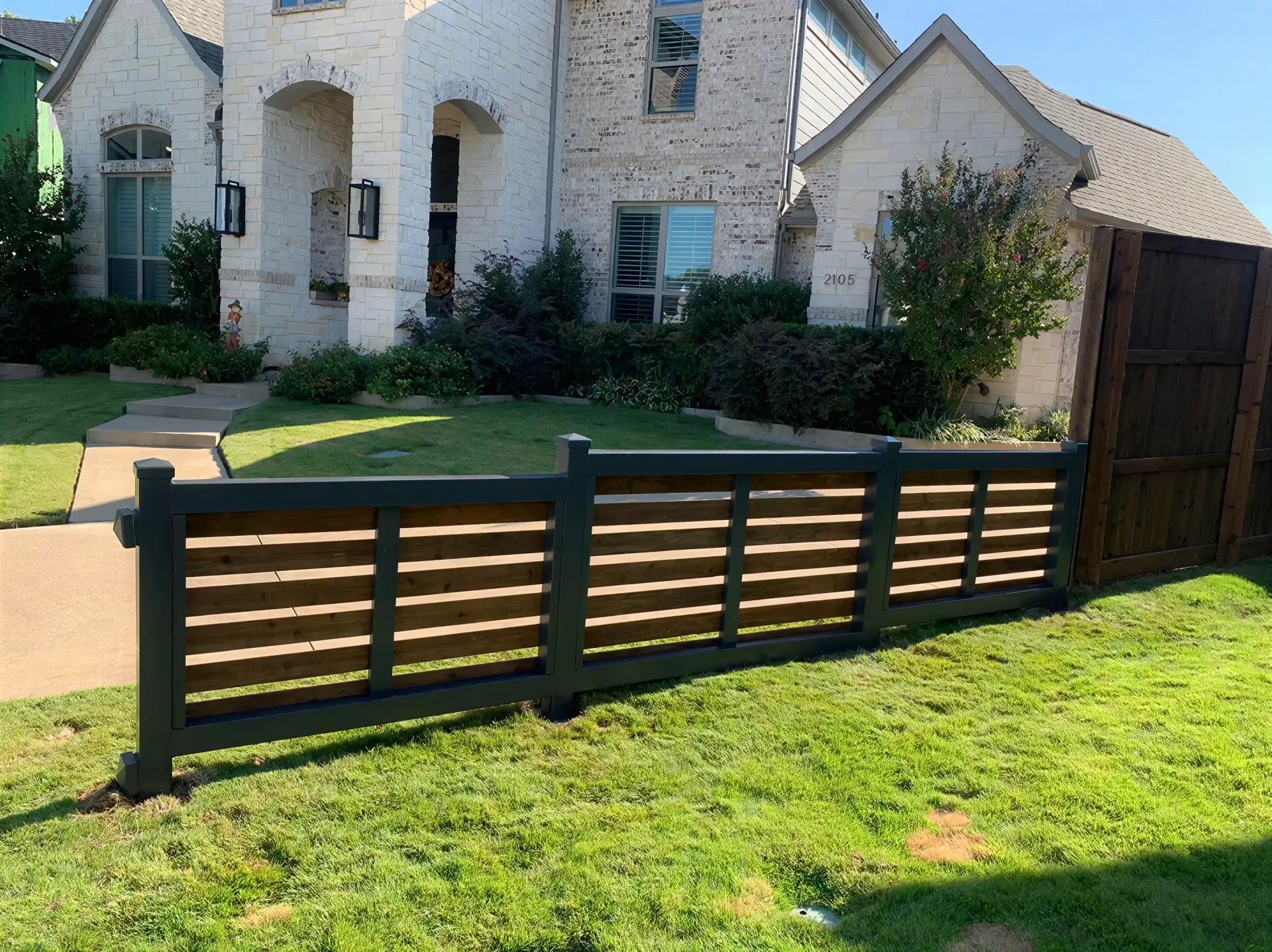 Seven-foot wood-and-iron privacy fence installed by Rollins Fence Company in Hurst, Texas