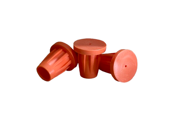 Three red wooden cups stacked and tipped on a white background