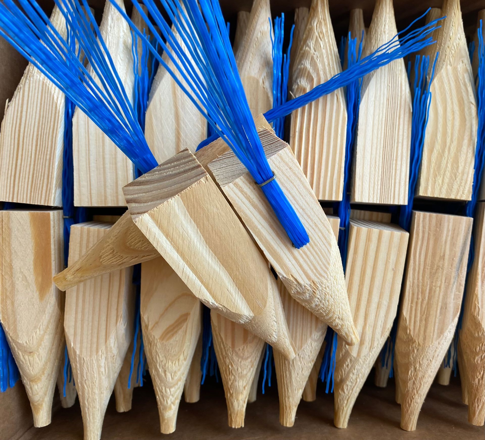 Close-up of woven blue and tan wooden spikes or stakes in a repeating pattern