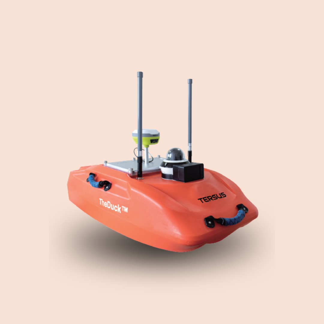 Orange autonomous boat robot with antennas and sensors on a plain background