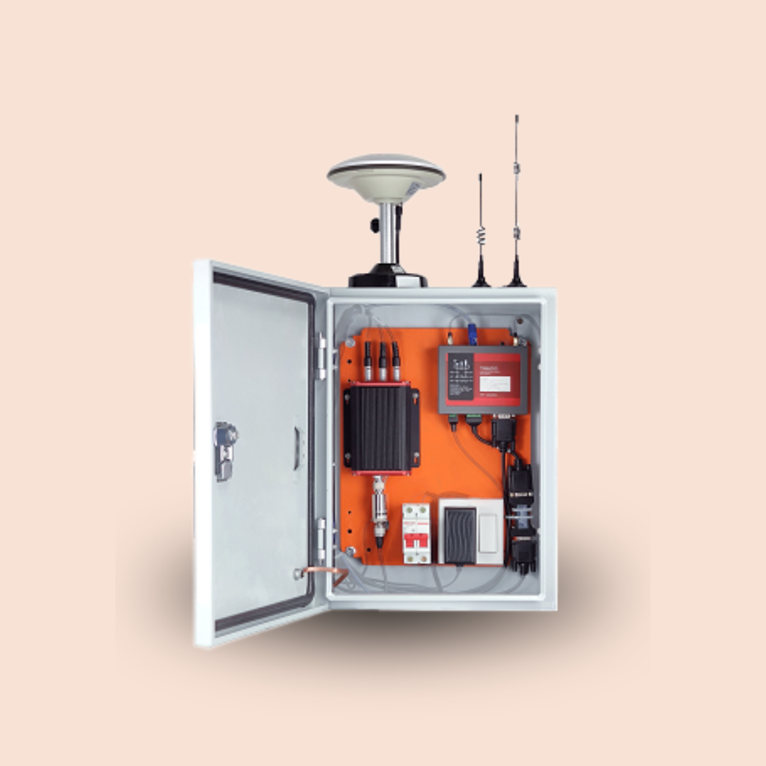 Open metal control box with orange electronics, antenna, and cabling inside