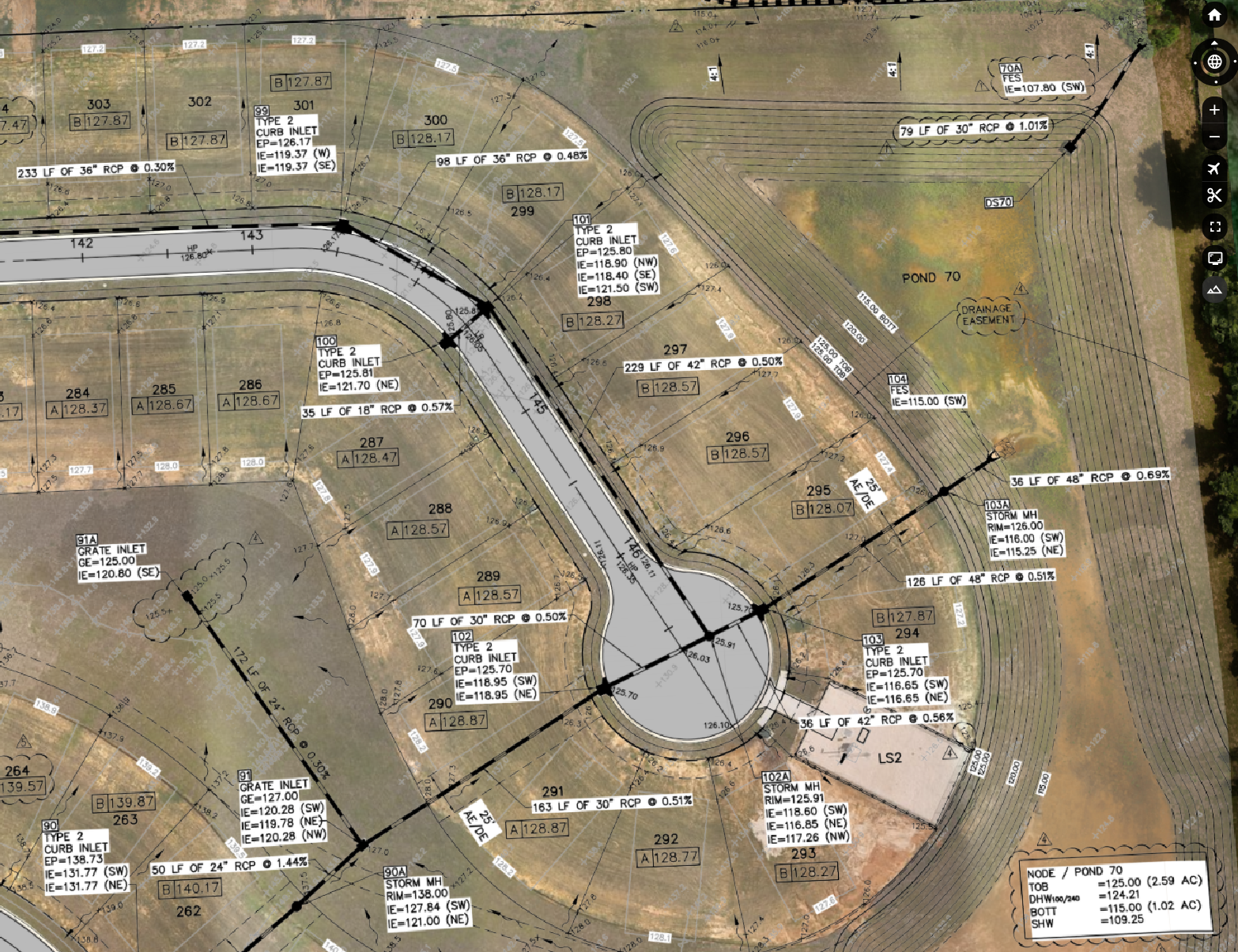 Aerial view of a paved road layout plan on a brown construction site with labels and markings.