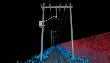 Nighttime railway with poles and overhead wires, lit by blue and red laser-like points on both sides