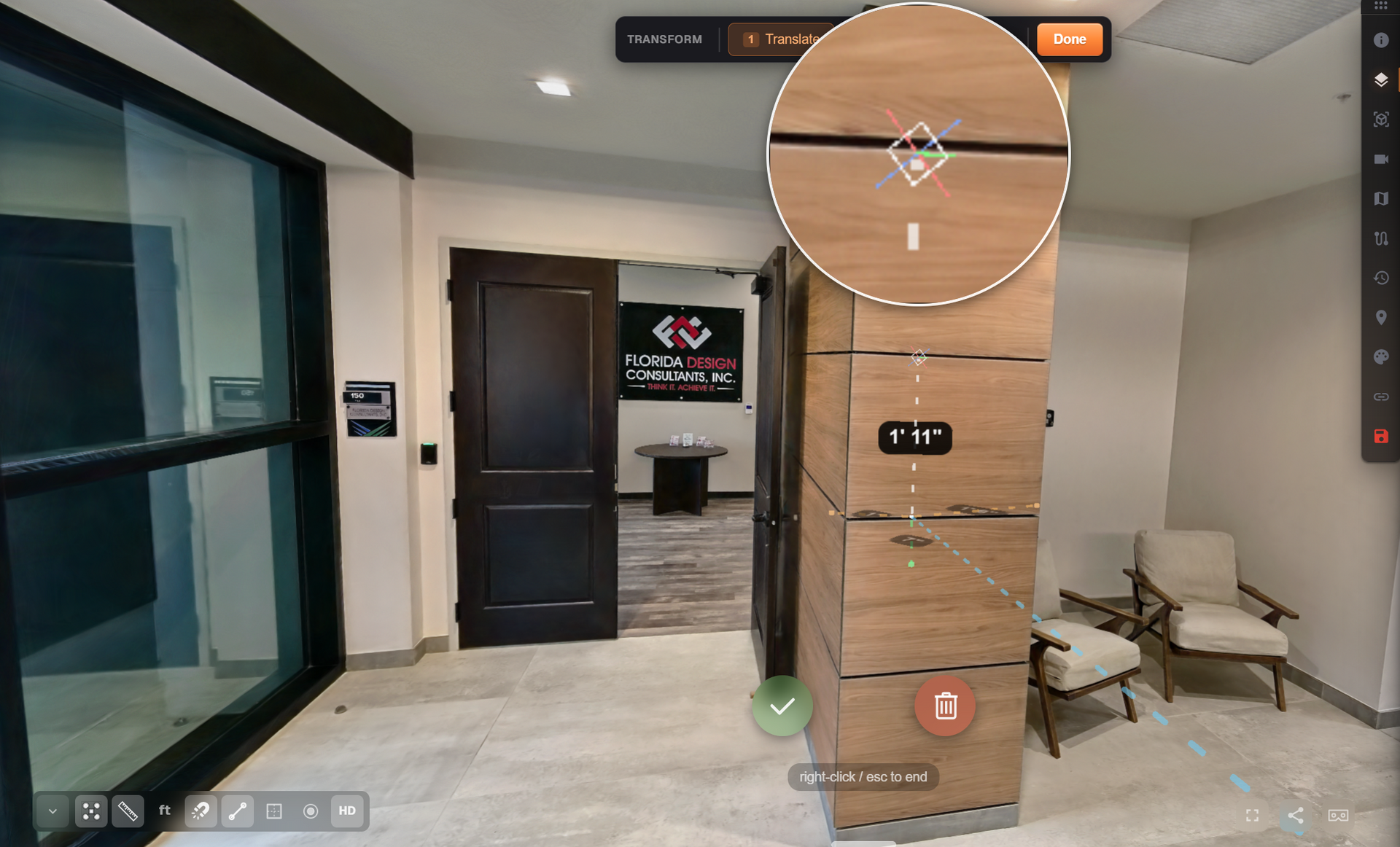 Modern apartment entryway with dark door, wood cabinet, glass wall, and chairs in a bright hallway