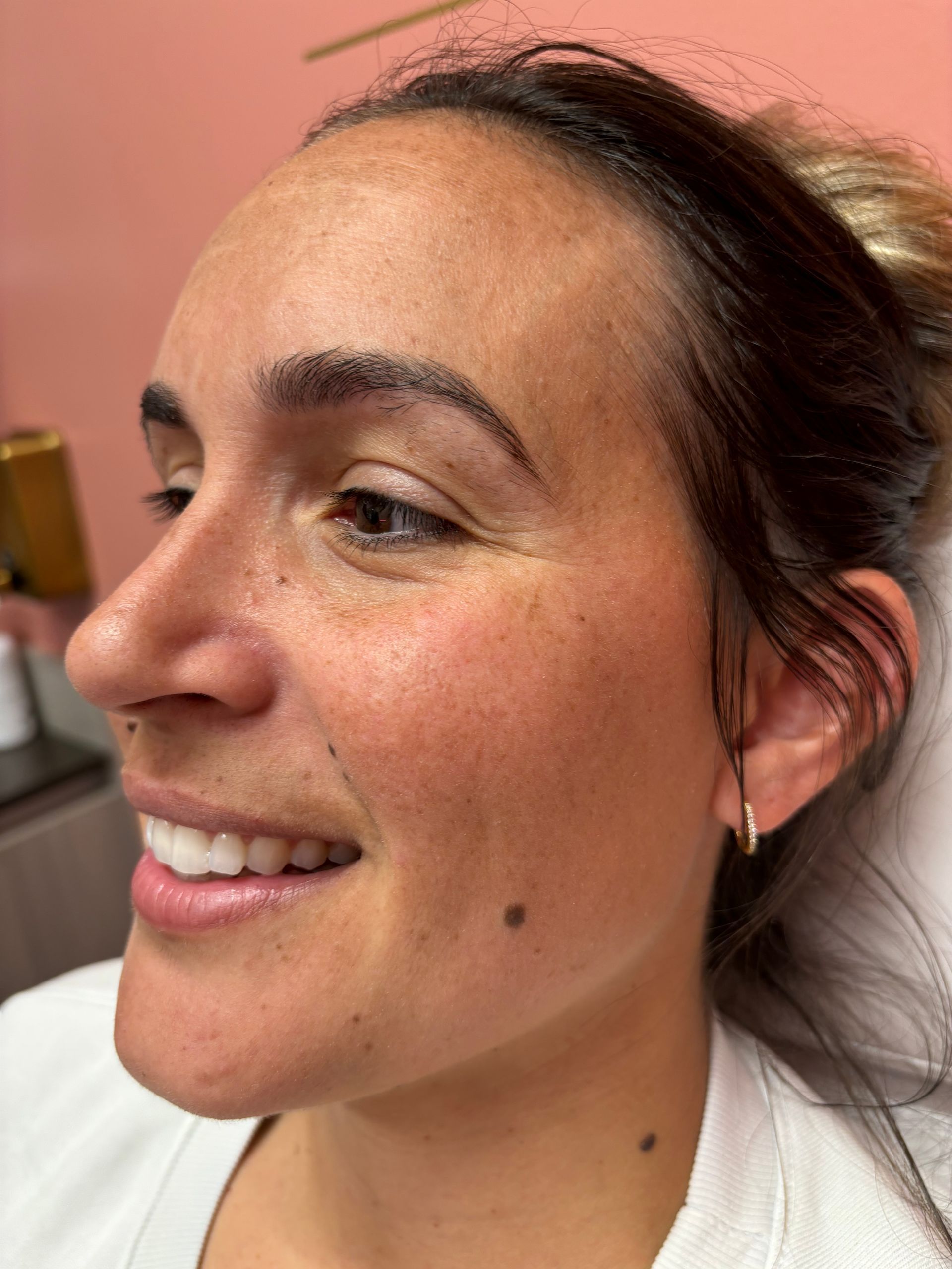 A close up of a woman 's face with a smile on her face.