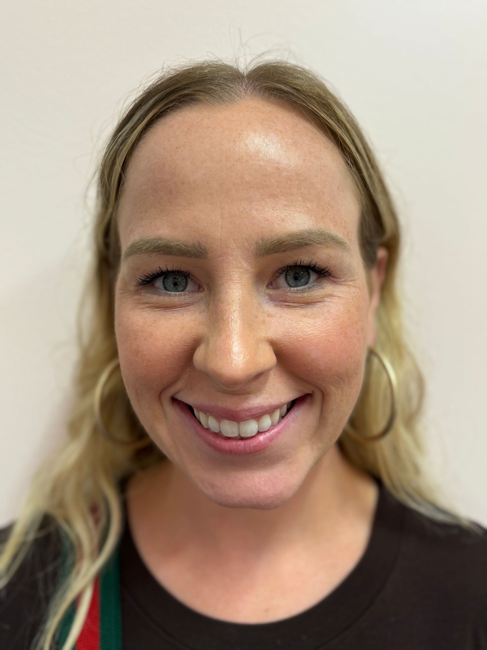 A close up of a woman 's face with a smile on her face.