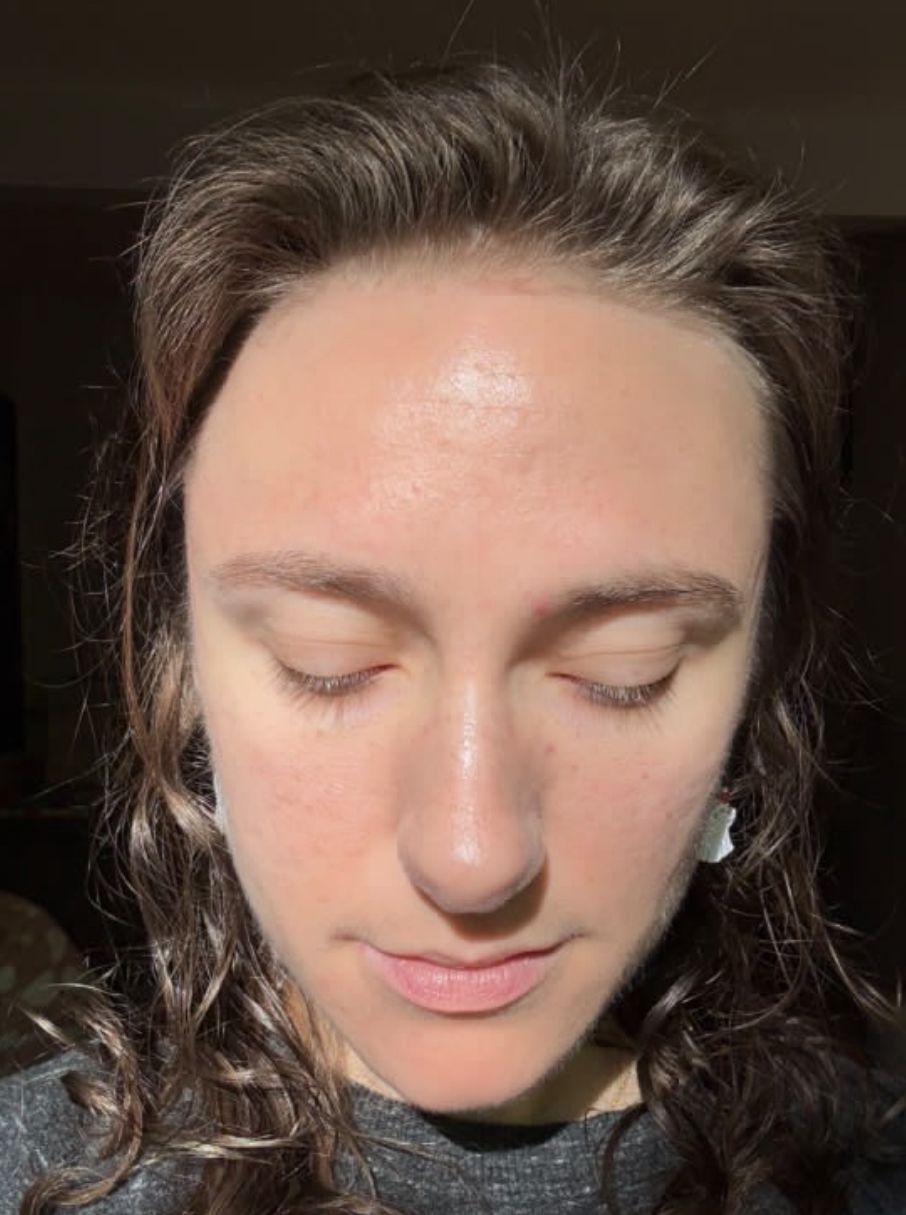 A close up of a woman 's face with her eyes closed.