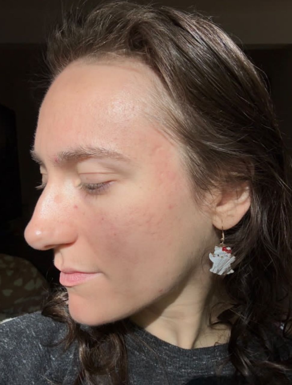 A close up of a woman 's face wearing earrings.