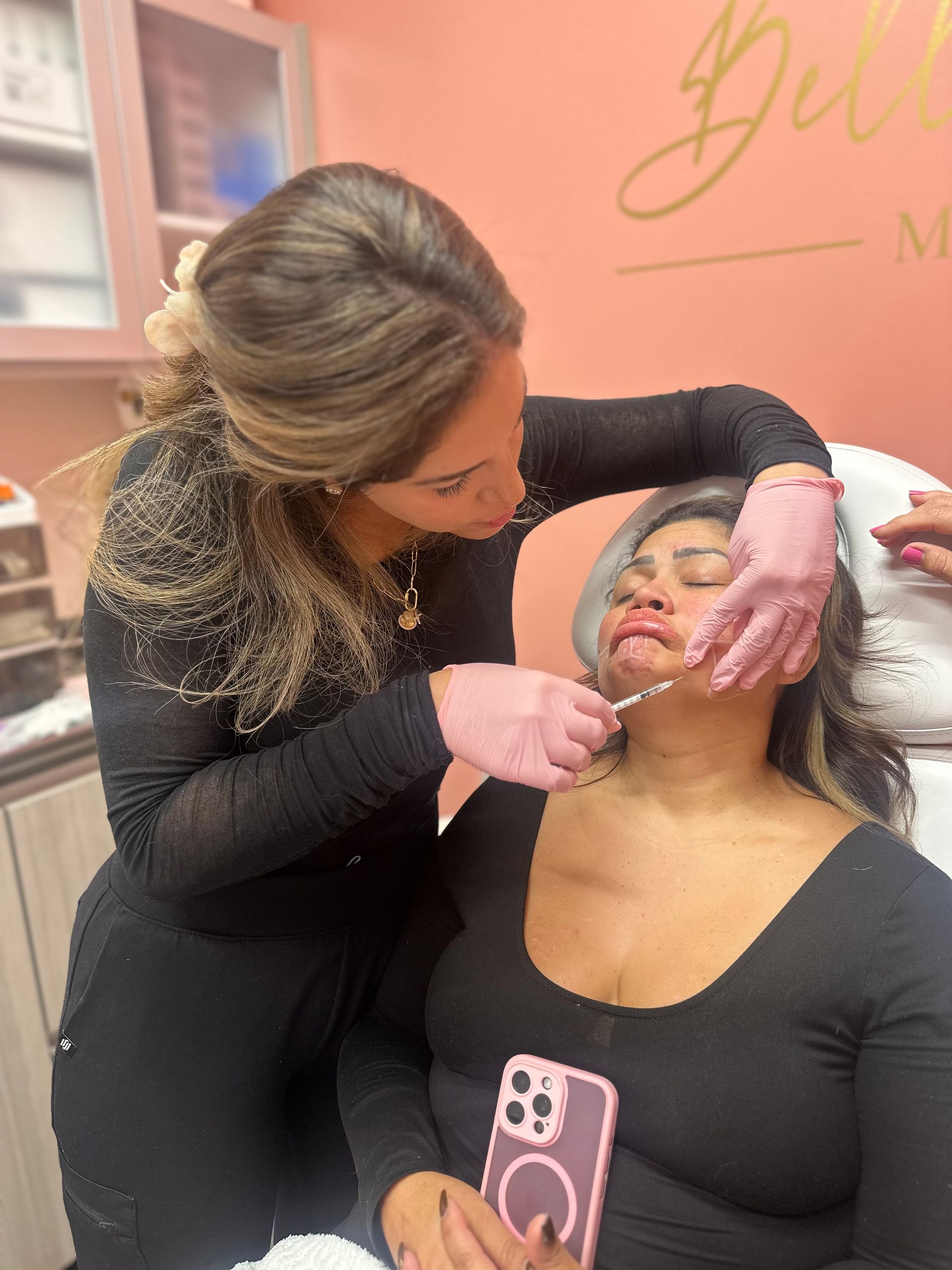 A woman is getting a botox injection in her forehead.