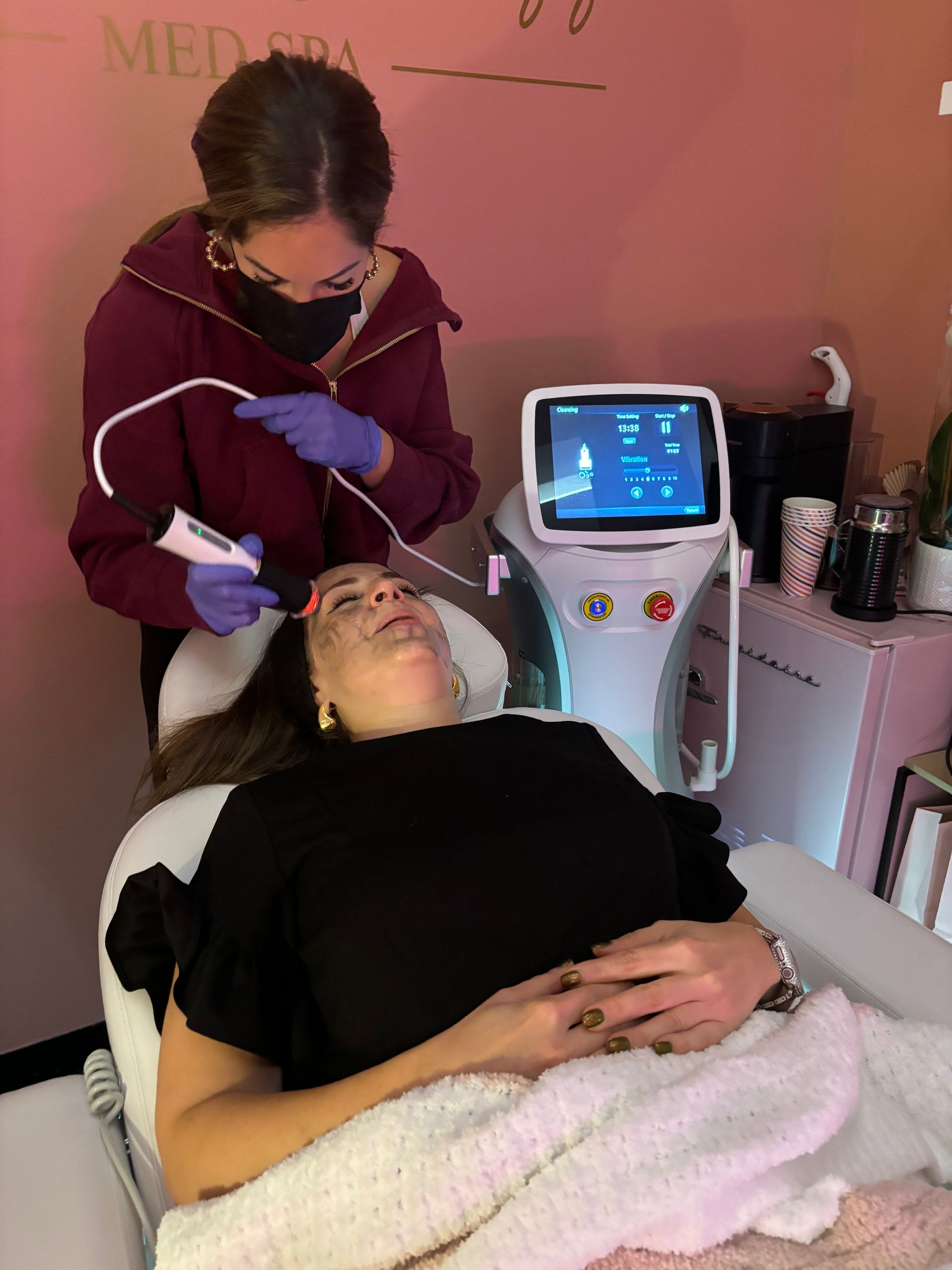A woman is getting a facial treatment at a beauty salon.