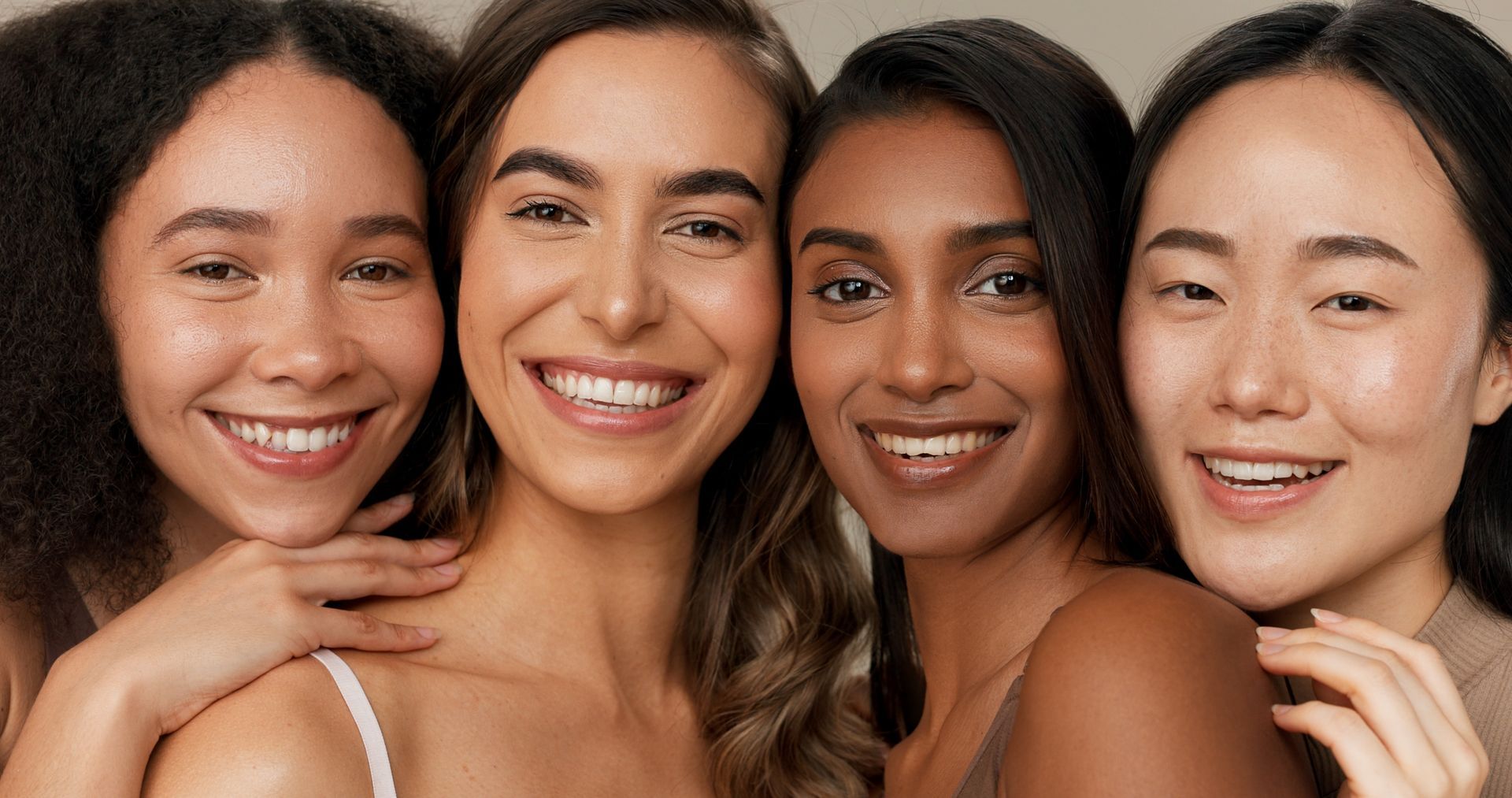 A group of women are smiling for the camera.