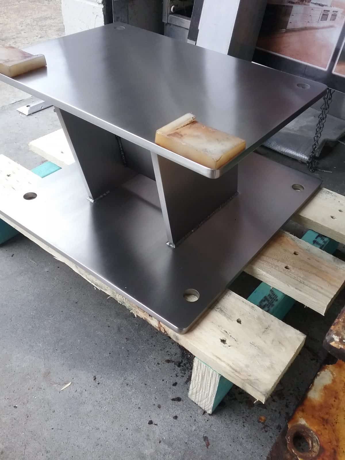 Stainless Steel Table With a Triangular Support, Sitting on a Wooden Pallet — Highlander Metals in Kirrawee, NSW