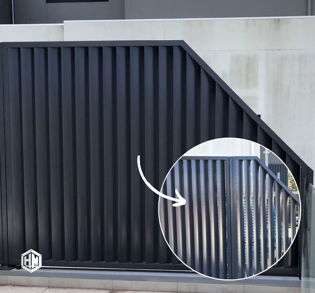 A matte black steel louver gate with an angled top corner, featuring a circular inset highlighting the gate's details — Highlander Metals in Kirrawee, NSW