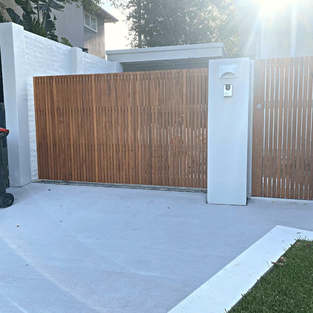 Wooden Gate and White Pillars in Front of a House, With Concrete Driveway — Highlander Metals in Kirrawee, NSW