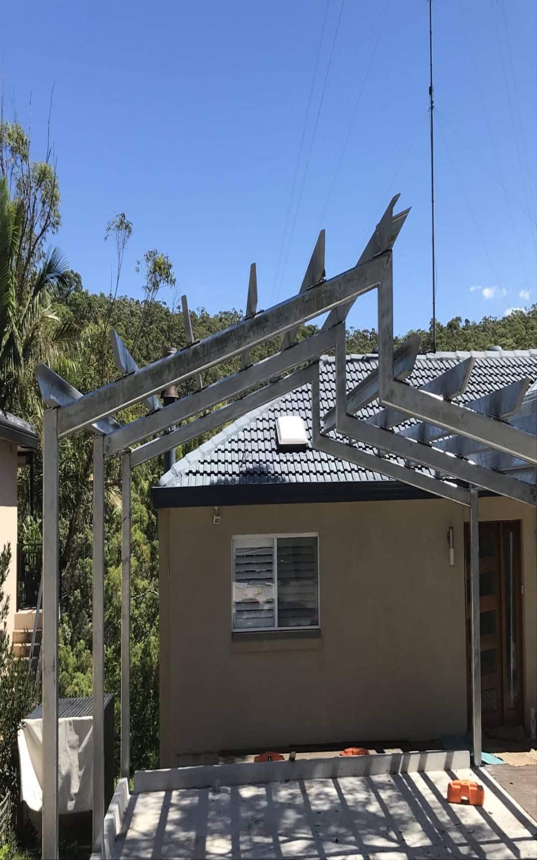 Metal Pergola Over a House; Antenna Towers in the Background, Blue Sky — Highlander Metals in Wollongong, NSW