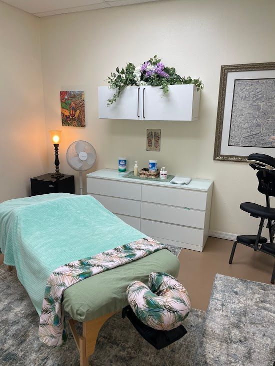 There is a massage table in the middle of the room.