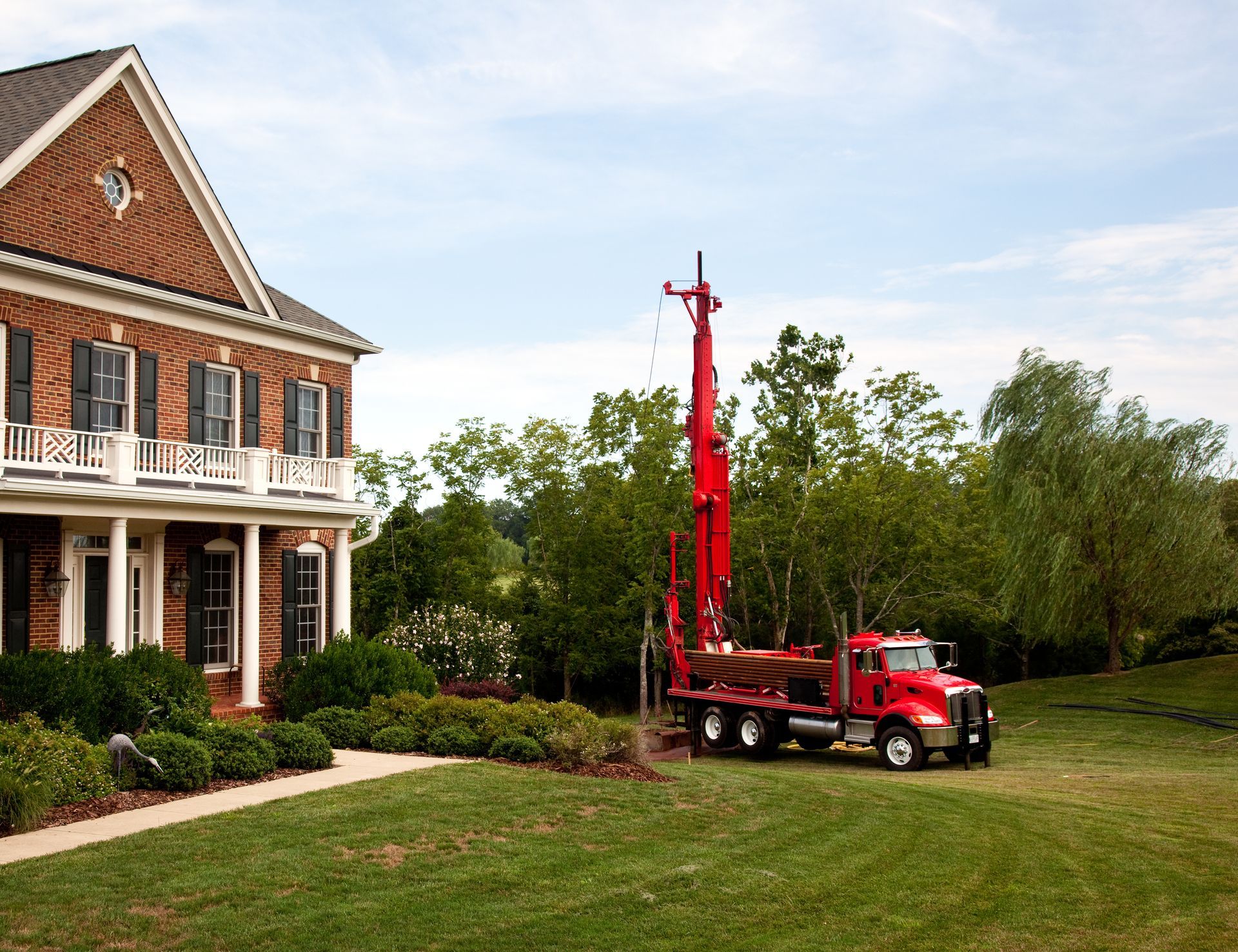 Drilling for geothermal power system in suburban yard.