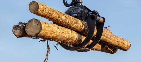 A crane is lifting a pile of logs in the air.
