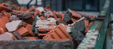 A pile of bricks and rocks in a dumpster.