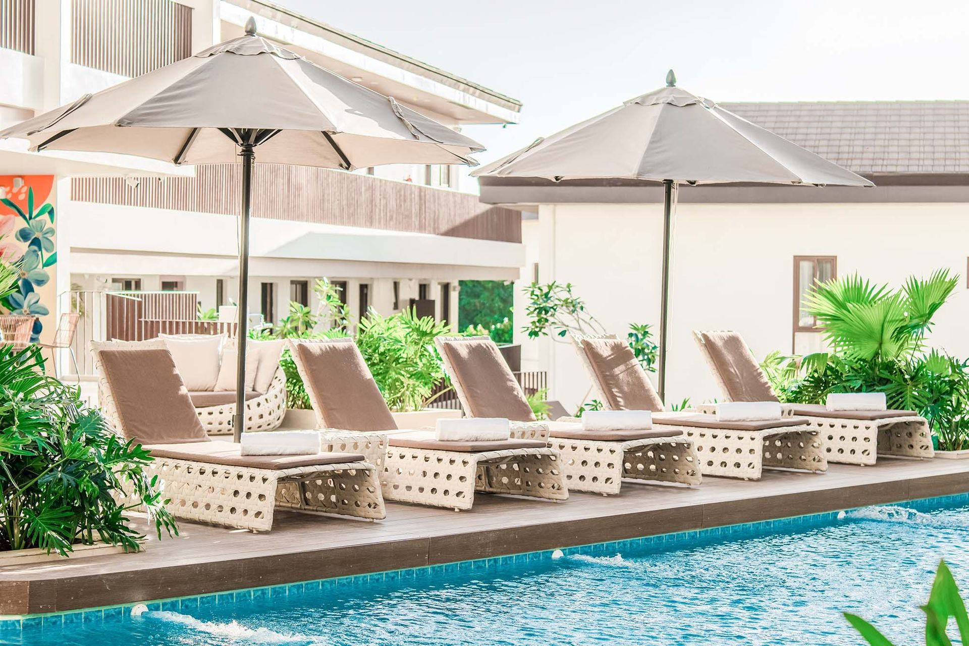 Luxury pool loungers with umbrellas at Charlie's El Nido Palawan Resort