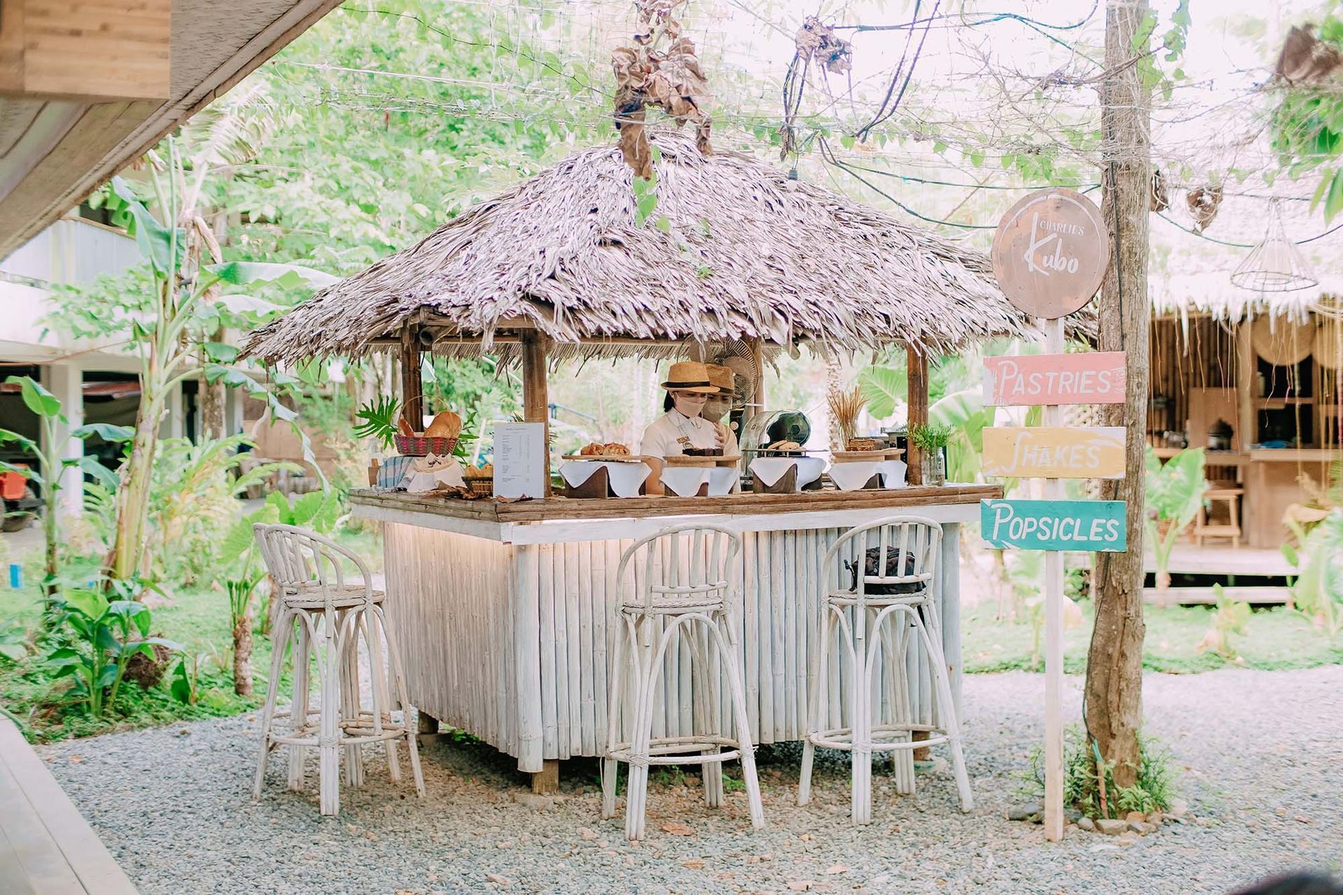 Outdoor bar counter at Charlie's Kubo & Baking Studio surrounded by pink flowering trees