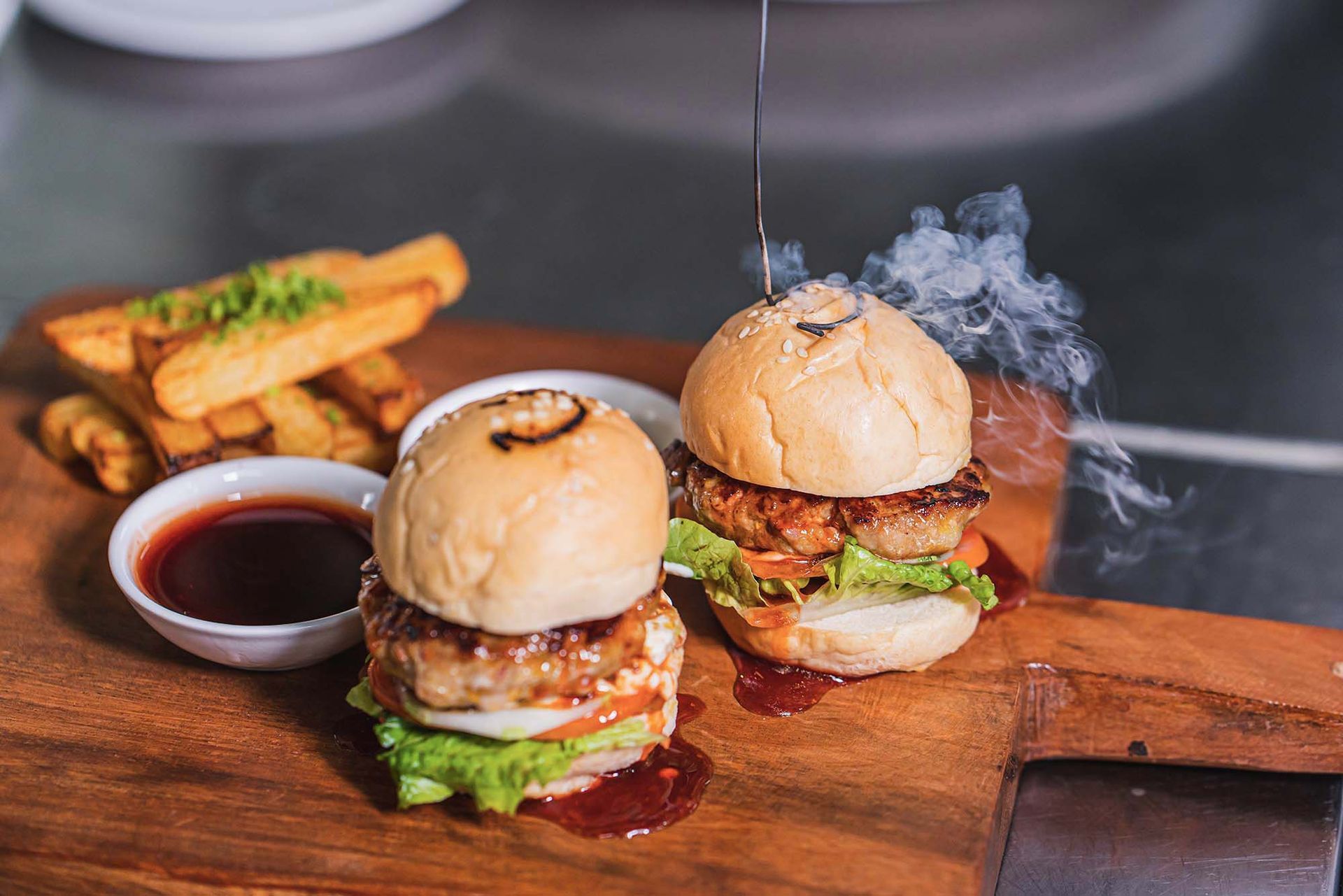 Smoky grilled chicken sliders with BBQ sauce and fries at Charlie's El Nido