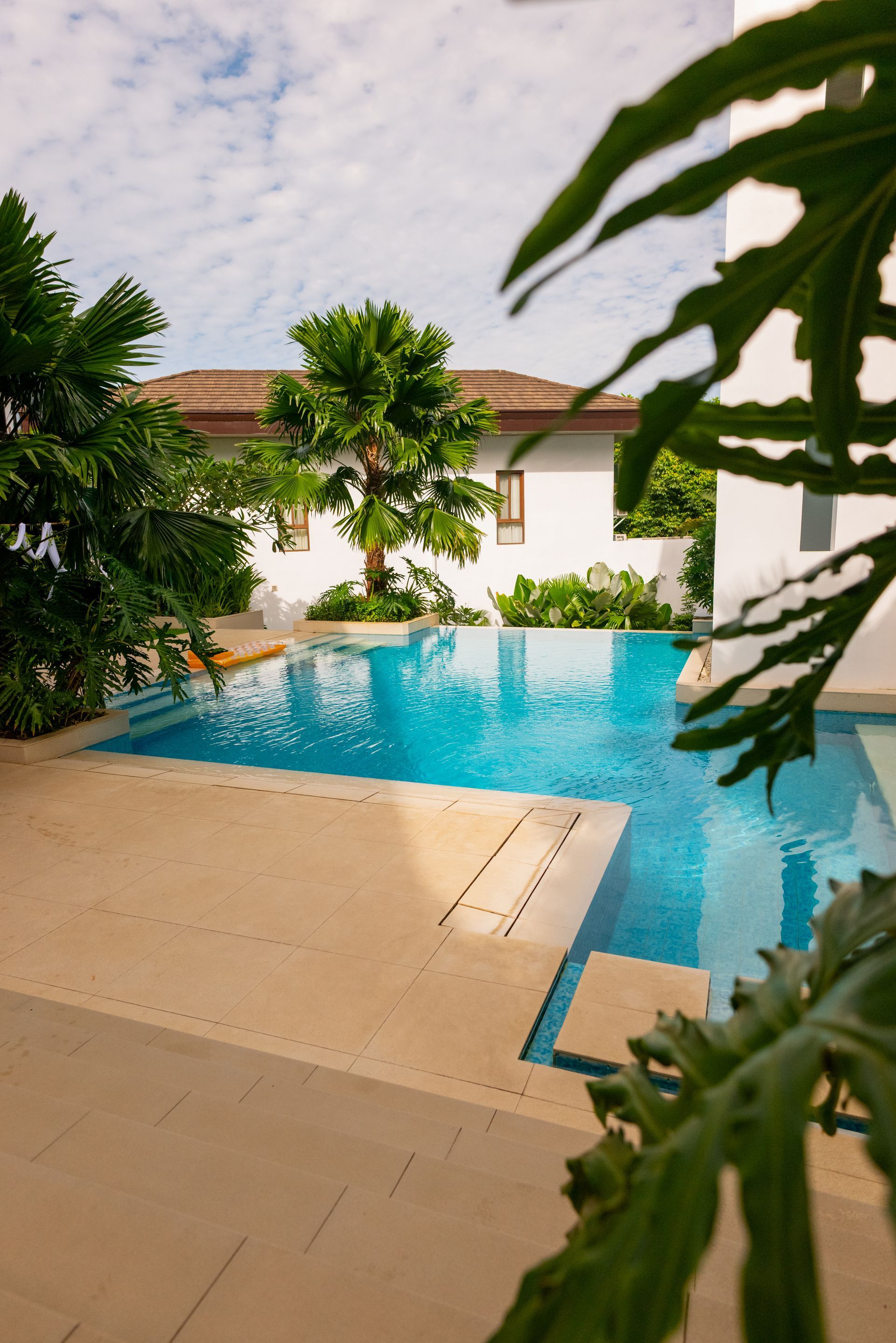 Luxury outdoor pool with tropical palms at Charlie's El Nido Palawan resort