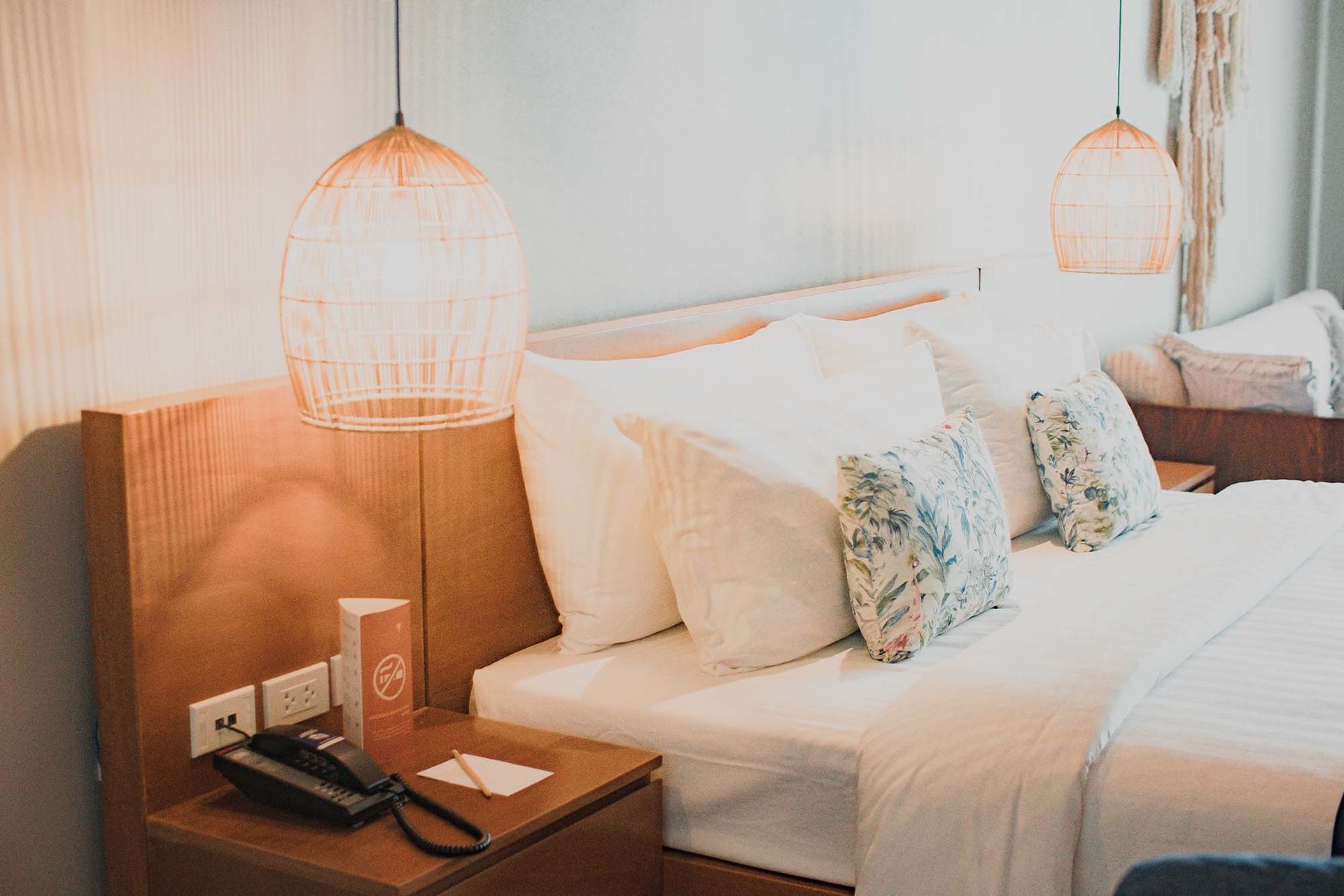 Charlie's romantic room with a bed , nightstand , and phone.