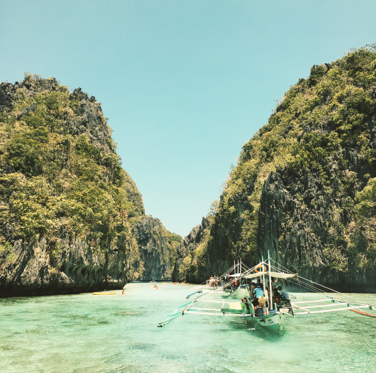 Traditional bangka boat on turquoise lagoon at El Nido Palawan Philippines