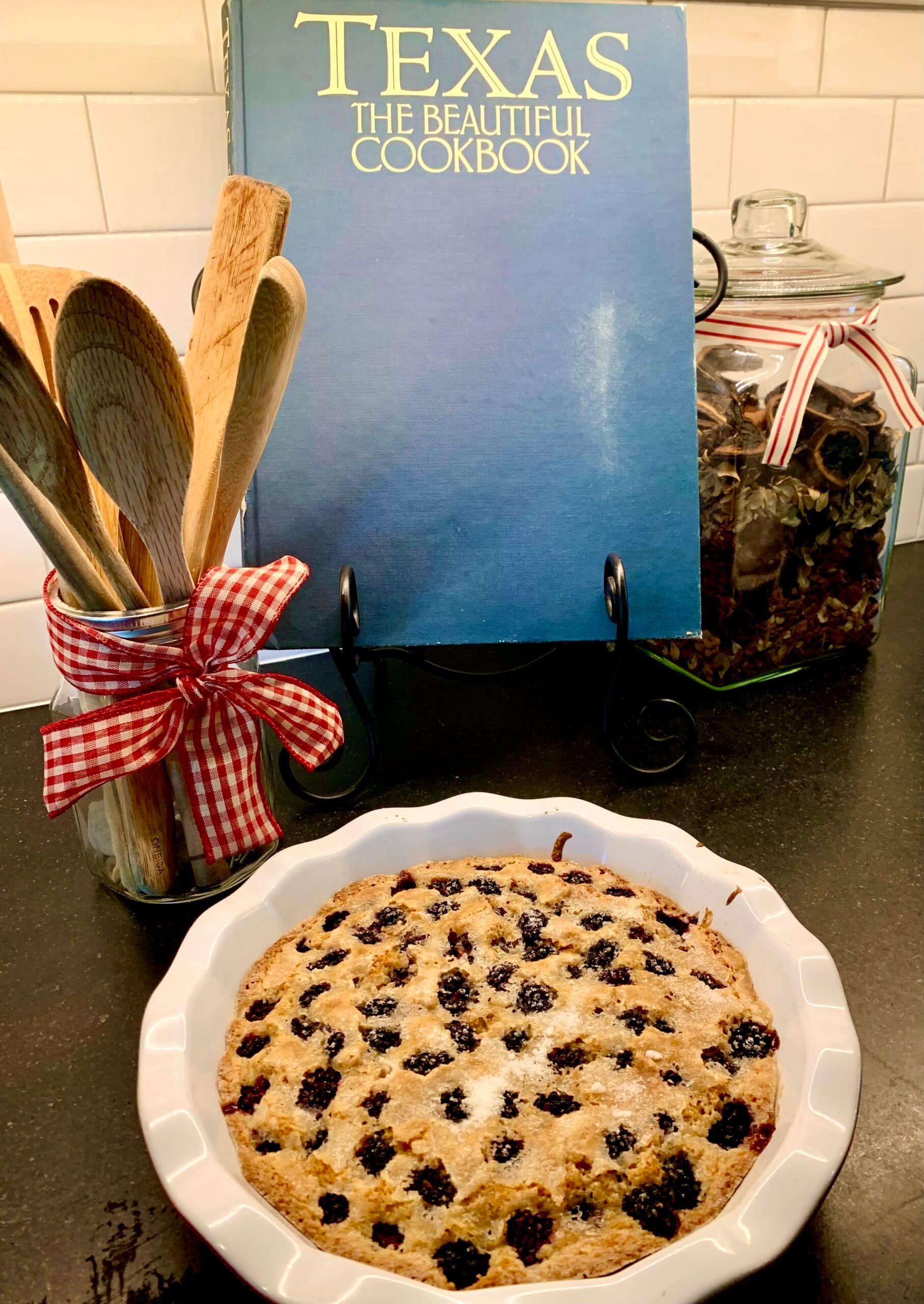 A pie in front of a texas cookbook