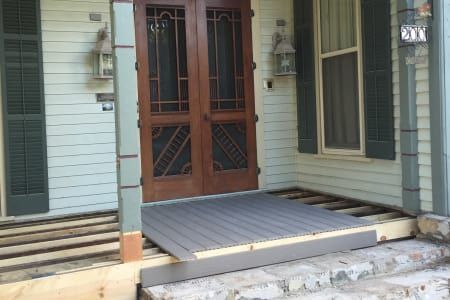 The front porch of a house is being remodeled