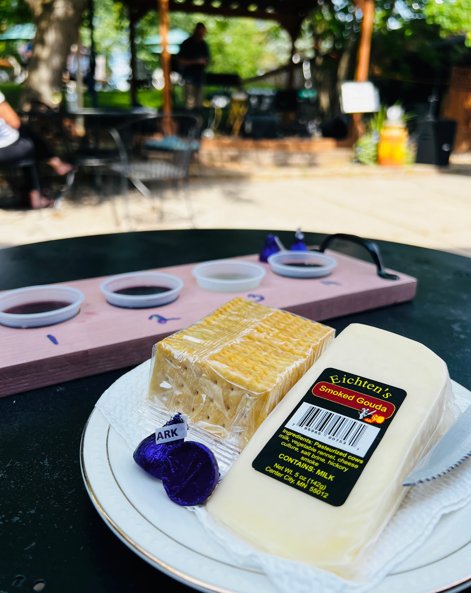 Dessert tray with two cakes on a plate at an outdoor café table