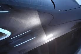 Car body with clear difference between polished and unpolished surfaces.