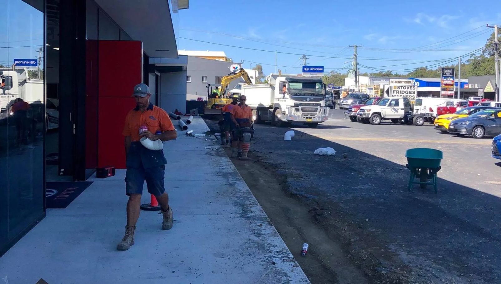 Plumbers in Coffs Harbour completing a commercial plumbing job on a large outdoor site with excavation equipment — Nambucca Plumbing in Coffs Harbour, NSW