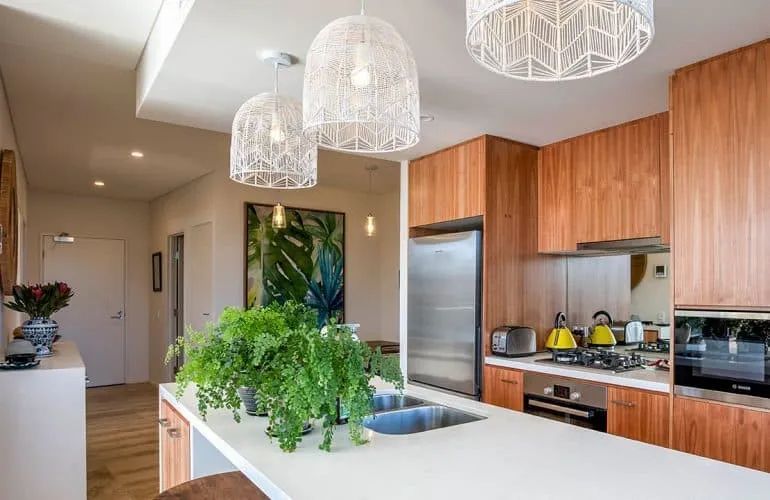 A Kitchen with Wooden Cabinets and Stainless Steel Appliances — Nambucca Plumbing in Nambucca Heads, NSW