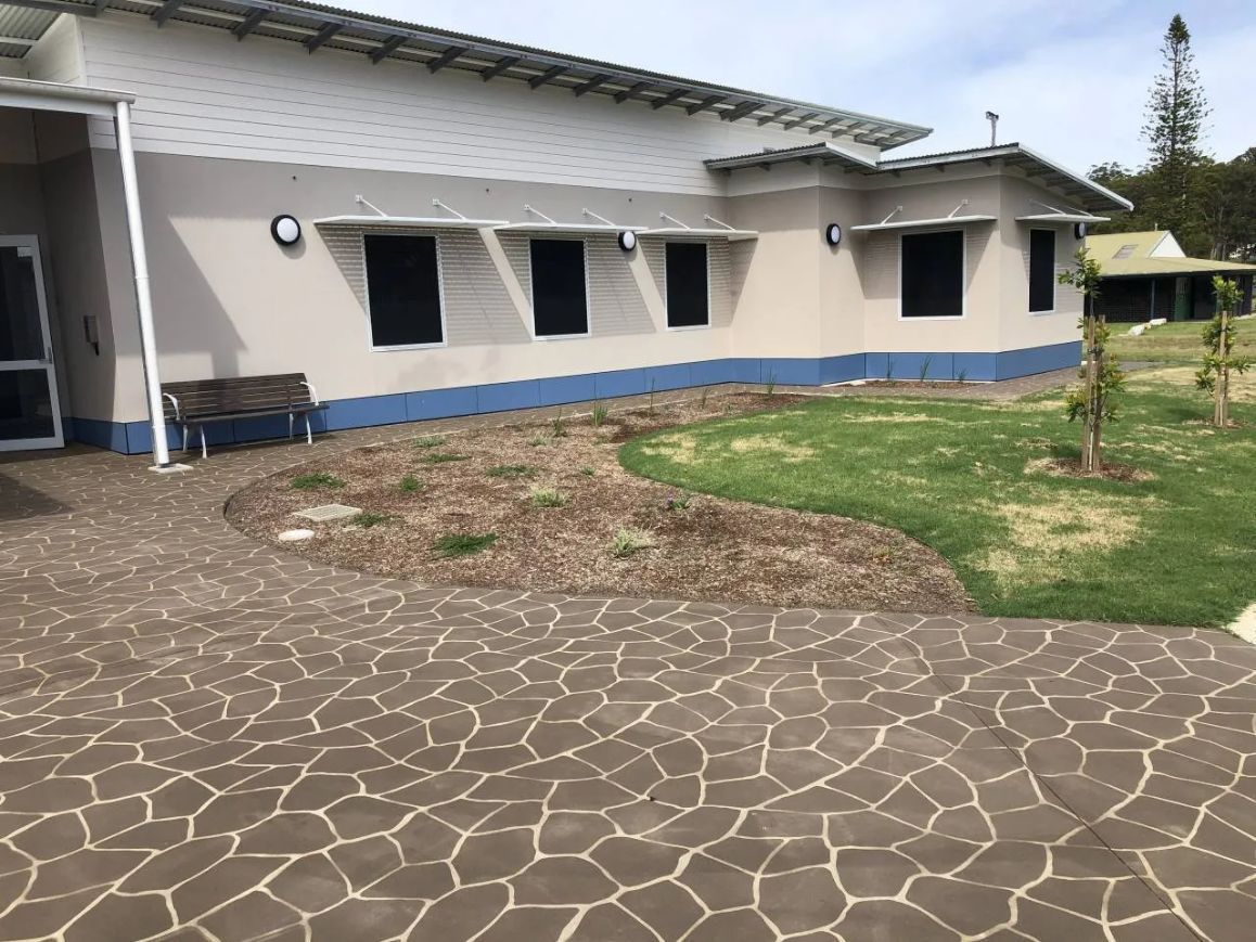 A Group of Children Are Playing on A Hill in A Building — Nambucca Plumbing in Nambucca Heads, NSW