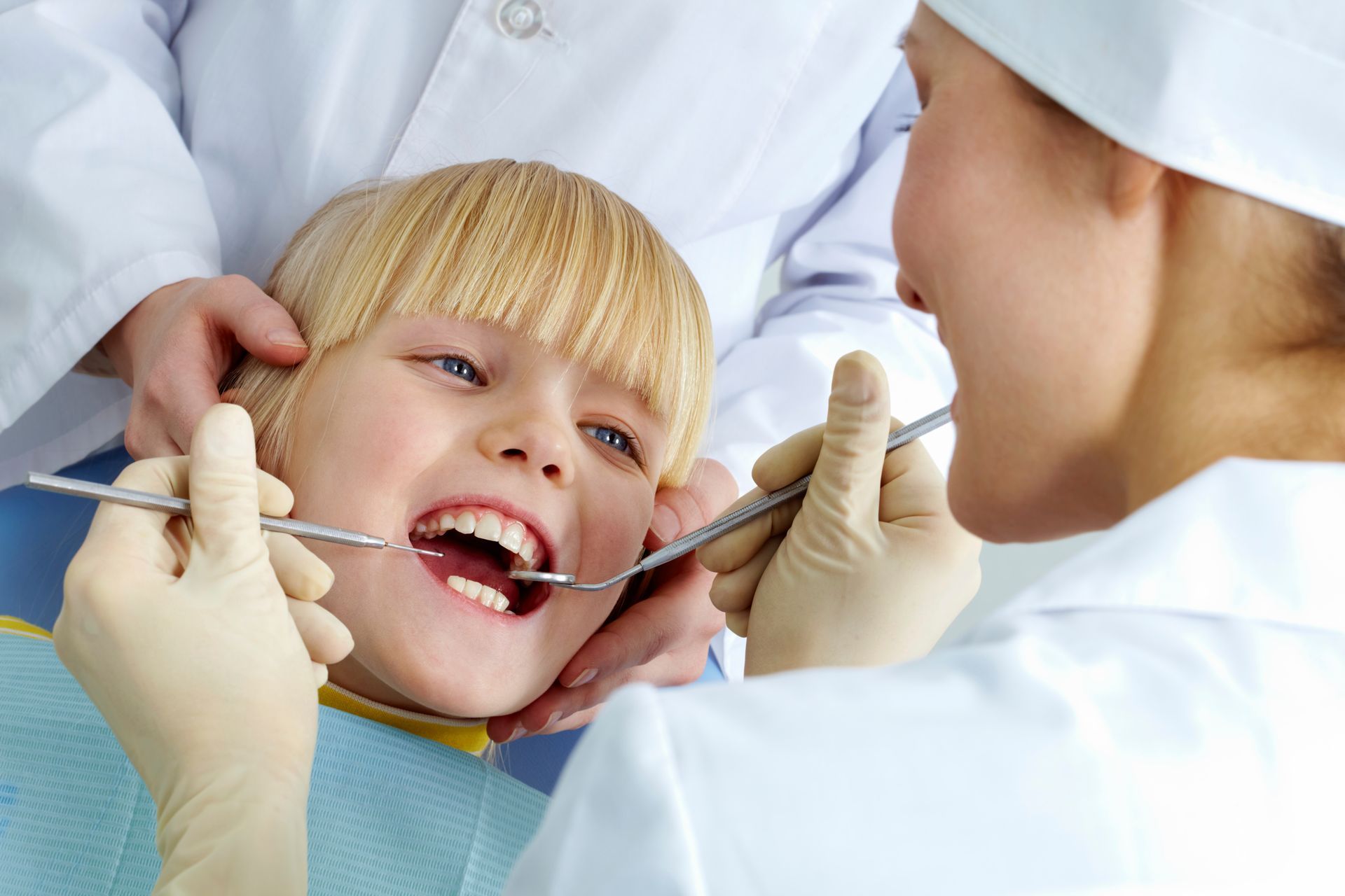A young girl receives a dental check-up at Kid Smiles, a children's dentist in Winston-Salem, NC, en