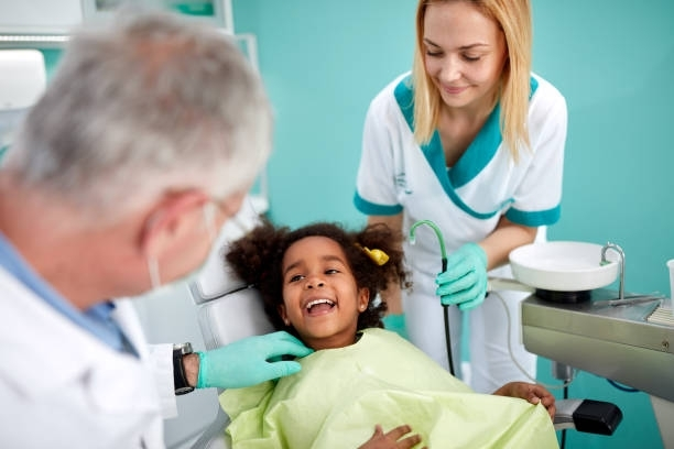 Children’s Dentist at Kid Smiles near Randleman, NC, examining a young patient’s healthy smile during a dental checkup.