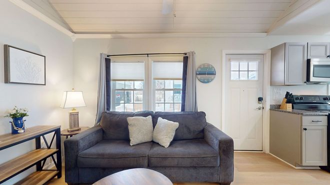 A bedroom with a bed and a ceiling fan.