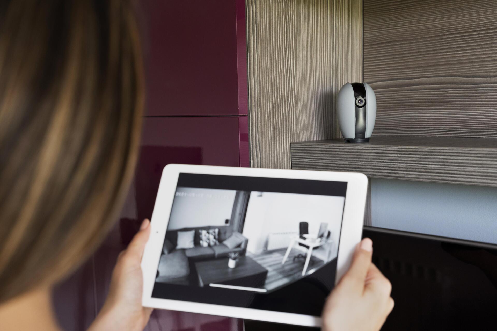 woman watching security footage on tablet