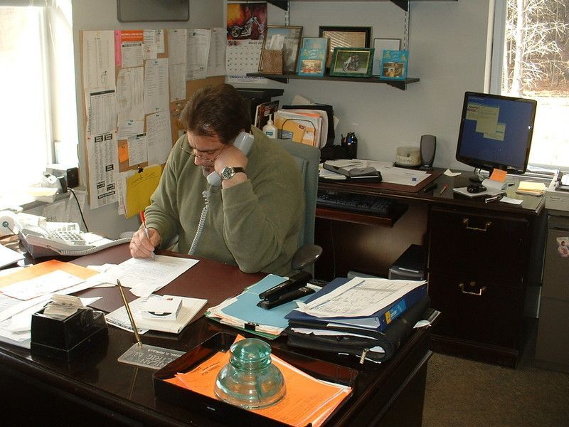 American Electric LLC | A man sits at a desk talking on a phone