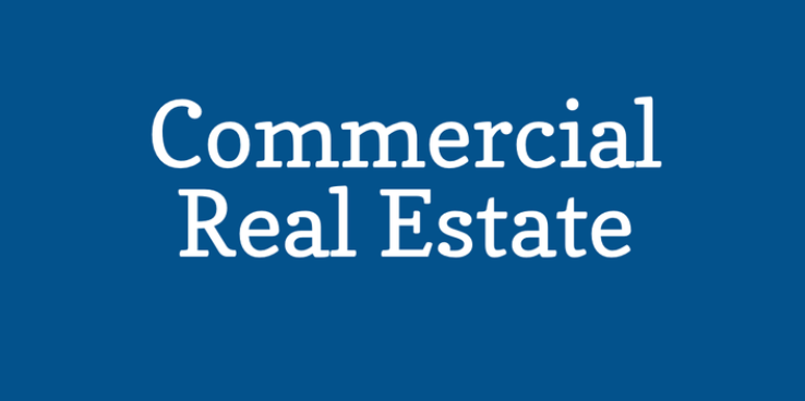 A blue background with white text that says commercial real estate
