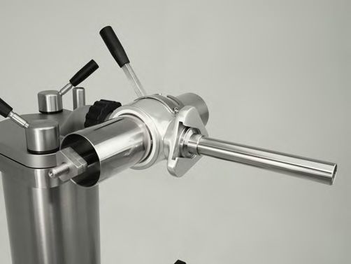 A close up of a stainless steel machine with three handles.