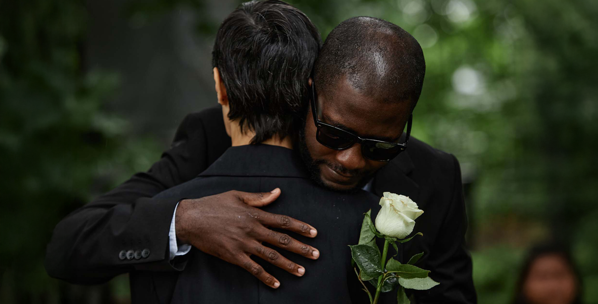 a woman hugging a man during a funeral service