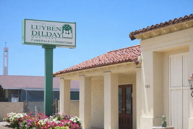 Long Beach, CA funeral home and cremations exterior with Luyben Dilday sign and red tile roof entry.