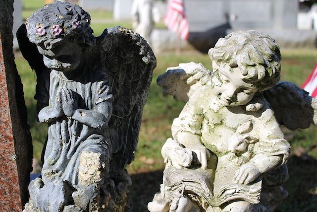 Weathered angel statues in a cemetery, symbolizing remembrance and peace, Long Beach, CA